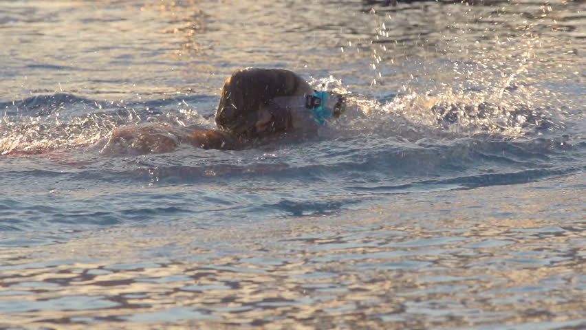 Slow Motion Shot Of A Little Girl Wearing A Diving Mask And Learning To Swim 