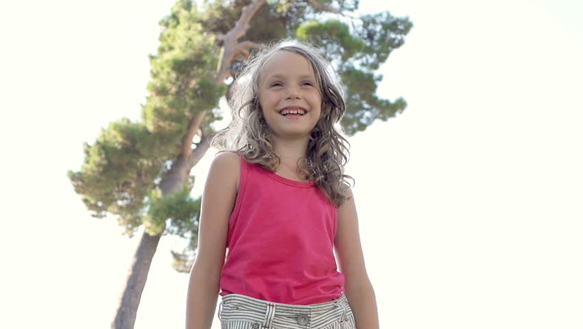 Slow Motion Shot Of A Cute Girl Smiling Happily In A Park