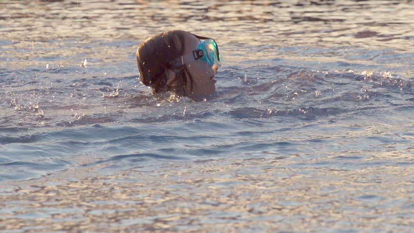 Slow Motion Shot Of A Little Girl Learning To Swim And Catching Her Breath