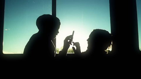 Silhouette of boy and mom