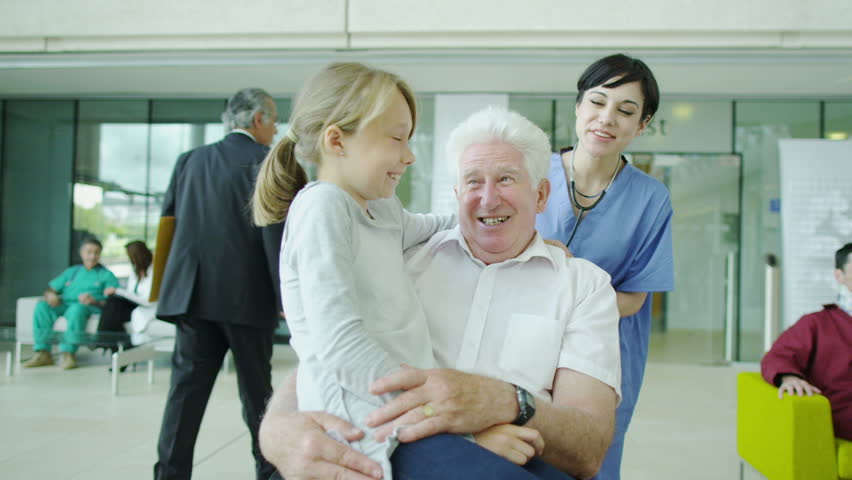 Caring doctors and nurses with patients in a modern hospital