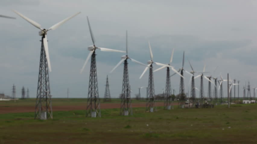Row of wind power generators on blue background