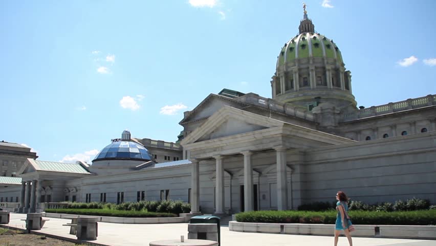A woman walks by the capitol building in Harrisburg, Pennsylvania.