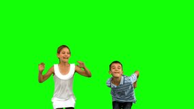 Siblings jumping together on green screen in slow motion - Powered by Shutterstock - Get 15% off with code: PIKWIZARD15