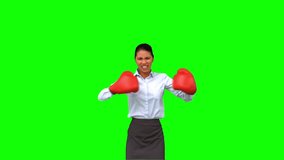 Determined businesswoman gesturing with boxing gloves on green screen in slow motion - Powered by Shutterstock - Get 15% off with code: PIKWIZARD15