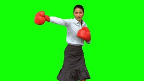 Businesswoman with boxing gloves hitting on green screen in slow motion - Powered by Shutterstock - Get 15% off with code: PIKWIZARD15