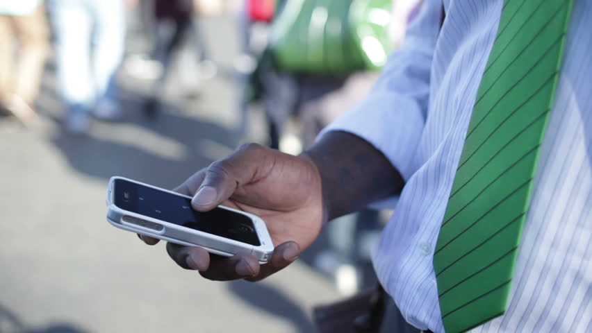 Businessman using his phone on London street 