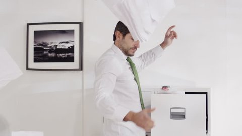 Funny businessman angrily goes through his filing cabinet. Slow motion.