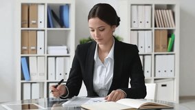 Young lady being busy analyzing financial reports