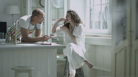 Loving husband or boyfriend offers a plate of freshly baked treats to his lover