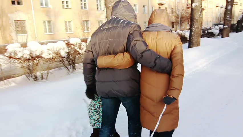 Little boy and his happy parents walking in Winter Park. 
