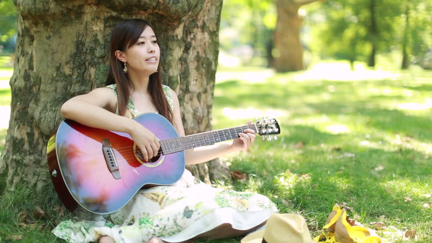 North korean girl playing guitar