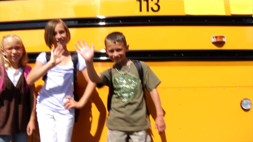 Students standing in front of school bus
