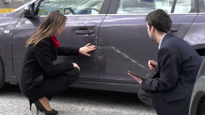 Woman and insurance agent discussing car damage Royalty-Free Stock Footage #4546373
