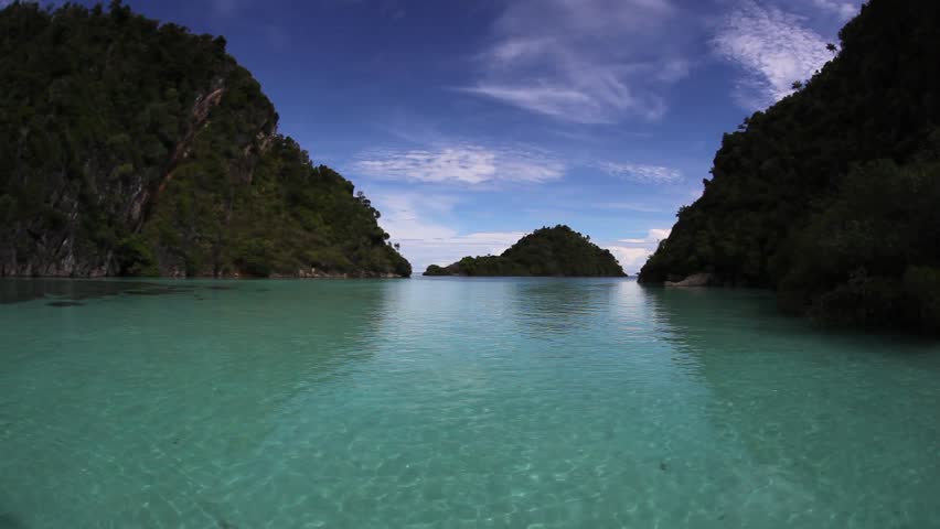 A shallow, sandy flat separates limestone islands in southern Raja Ampat,