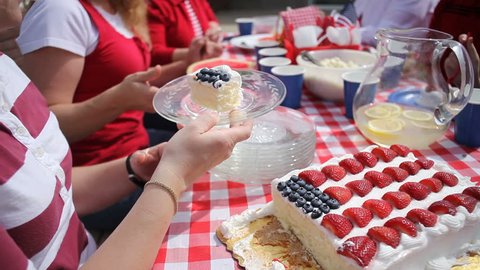 Passing cake at 4th of July party Stock Video