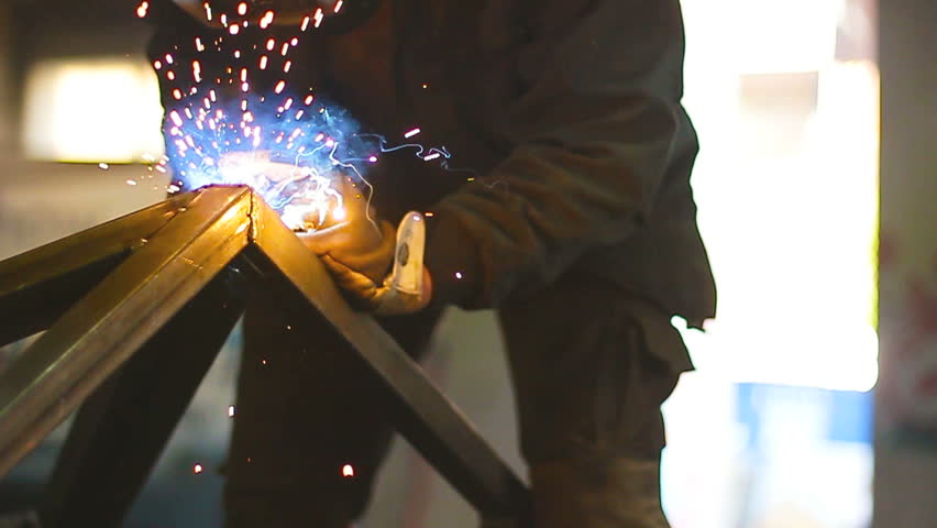 Worker working with welding in a workshop