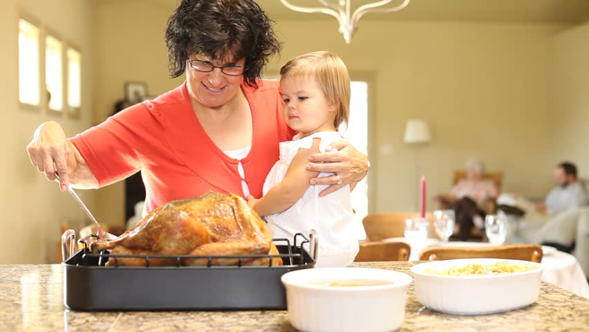 Woman basting Thanksgiving turkey