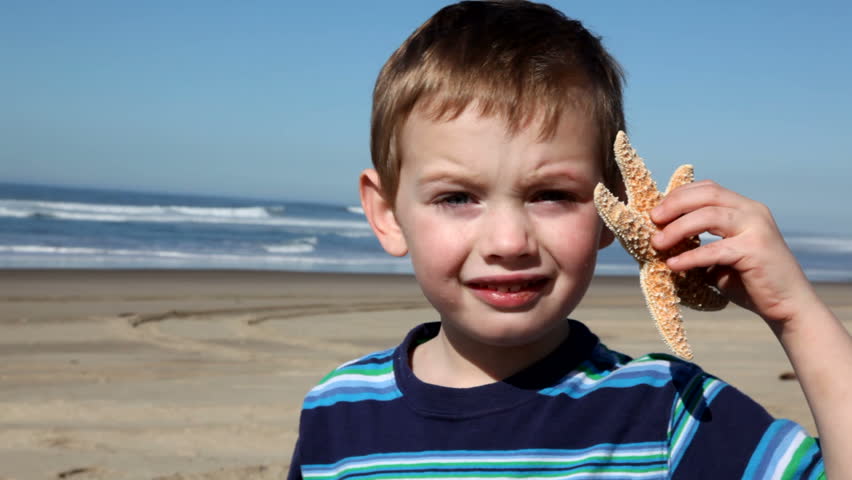 Boy holds up starfish