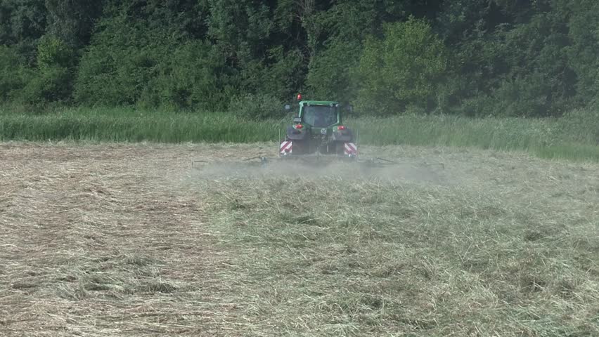 Farmer turning hay