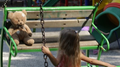 Child Swinging, Girl Playing with Teddy Bear Toy at Playground in Park, Children