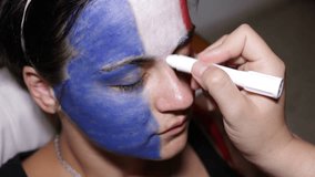 Woman face painting flag of France