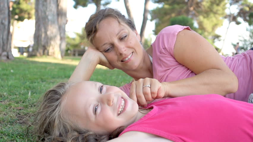 Slow Motion Shot Of Mother Caressing Her Daughter's Hair In The Park