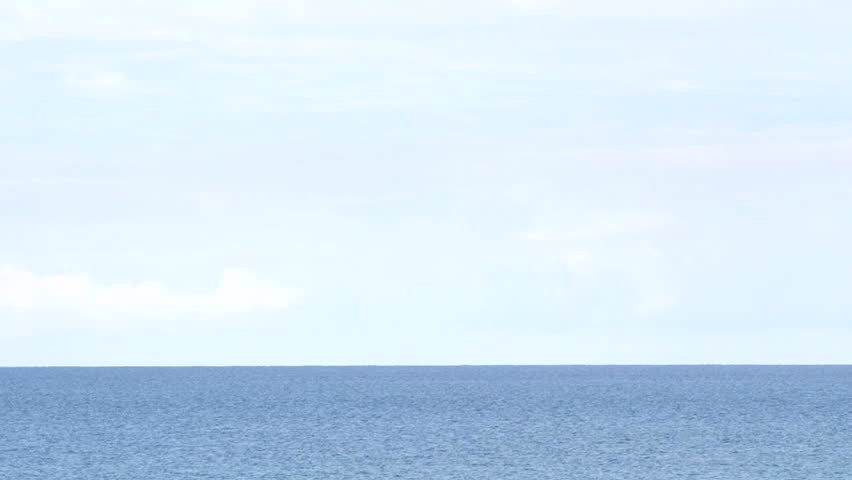 Blue ocean water and empty sky horizon background.