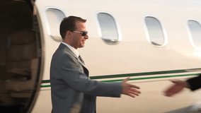 Businessmen shaking hands by jet - Powered by Shutterstock - Get 15% off with code: PIKWIZARD15