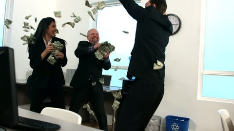 Businesspeople throwing money, slow motion
