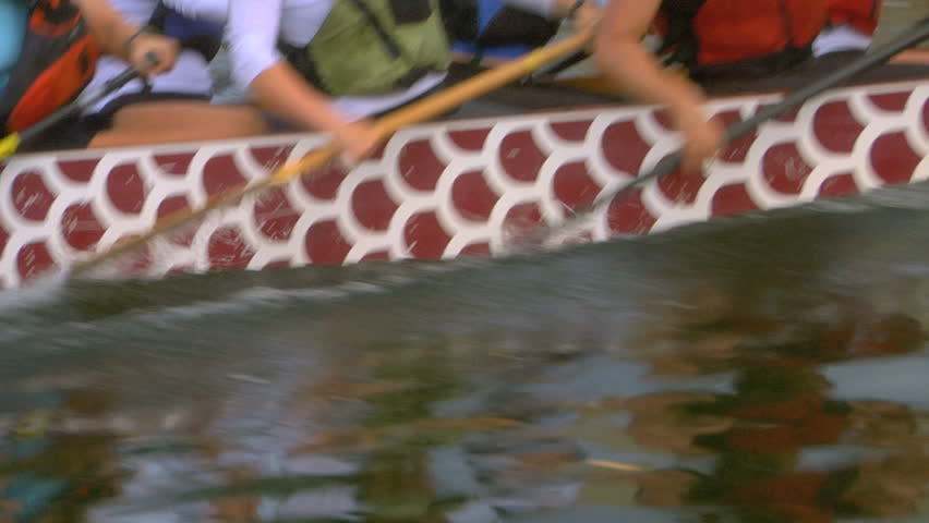 Close-up of a Dragon boat team racing.
