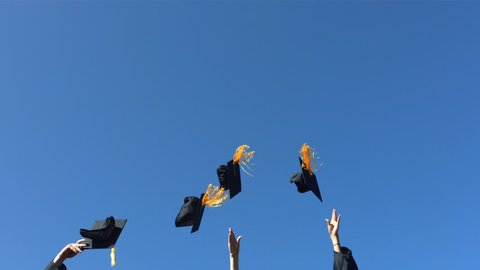 Tossing graduation caps, slow motion
