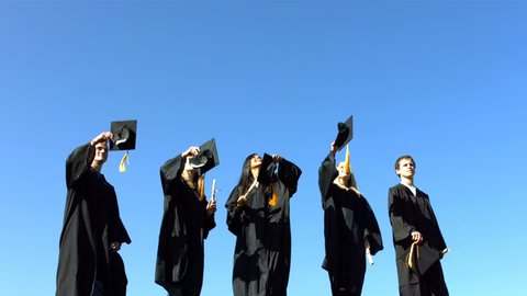 Group of graduates throwing graduation caps