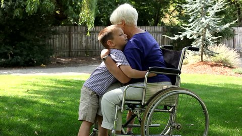 Senior woman in wheelchair gets hugs