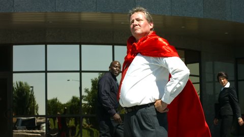 Businessman wearing superhero cape