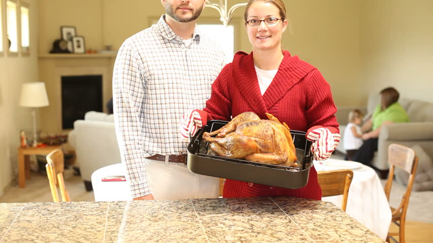 Portrait of couple with Thanksgiving turkey