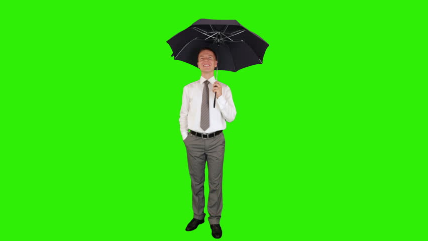 Young businessman opening umbrella, Green Screen