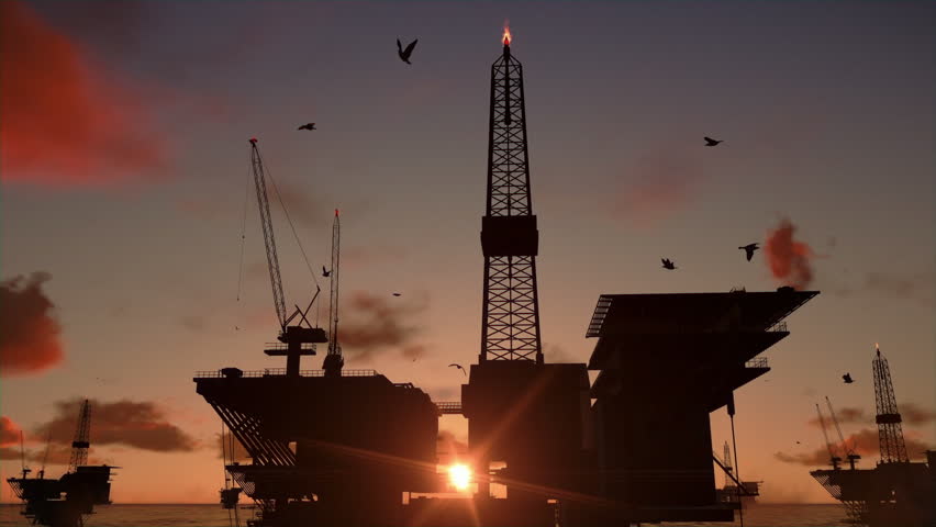 Oil rigs in ocean, time lapse sunrise