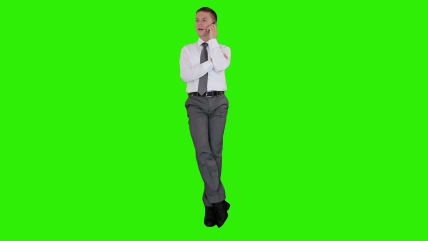 Young businessman on mobile and sitting, Green Screen