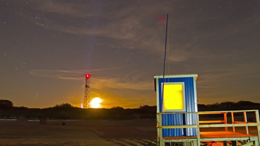lifeguard hut on the beach at night , time-lapse
