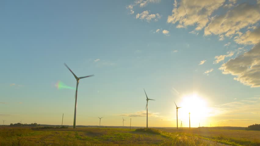 Windmills generators at sunset, timelapse
