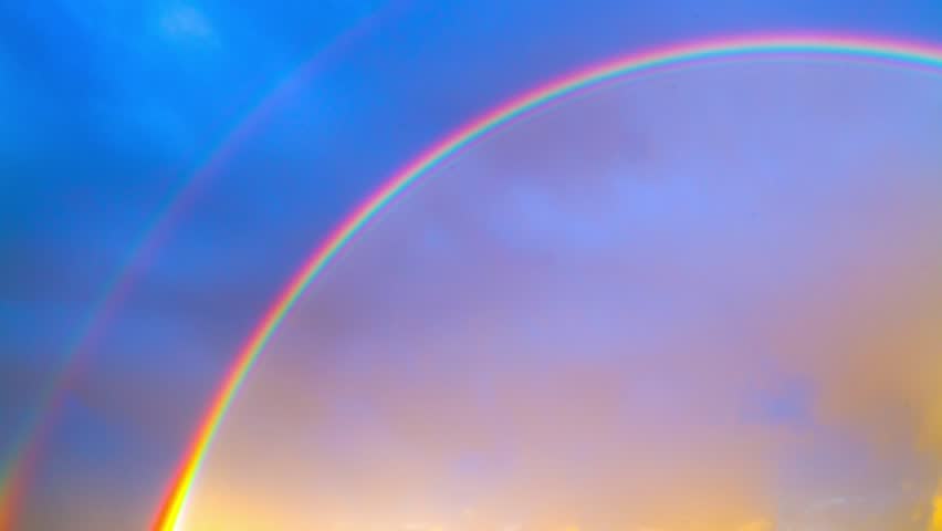 rainbow on blue sky, time-lapse