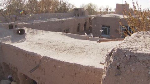 A backyard in a suburb of Herat / Afghanistan. Houses made of mud, lots of people living in poverty.