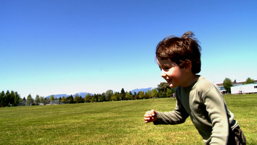 Little boy running outside