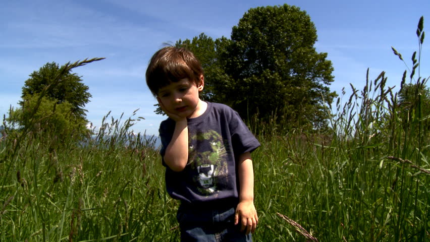 Little boy walking in the field