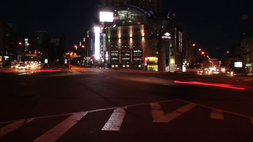 Night time lapse, cars leave light traces, moving on crossroads