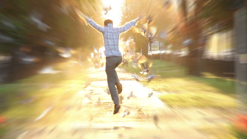 Man jumps high super slow motion shot heaven sun light birds fly