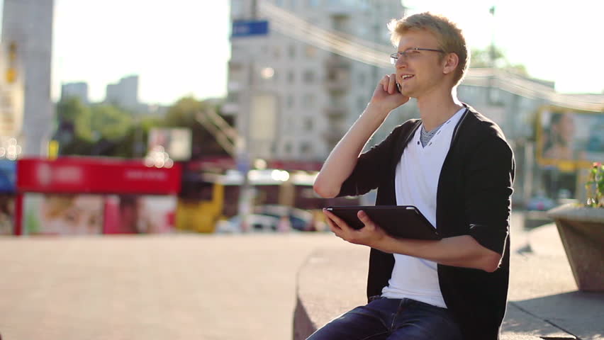 Man in city talking over mobile phone enjoying conversation