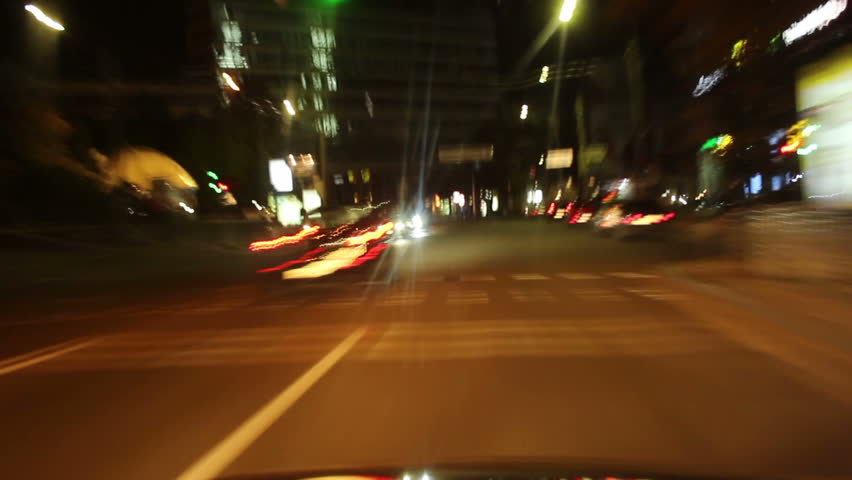 Driving night city car timelapse, streets fly, cars leave traces