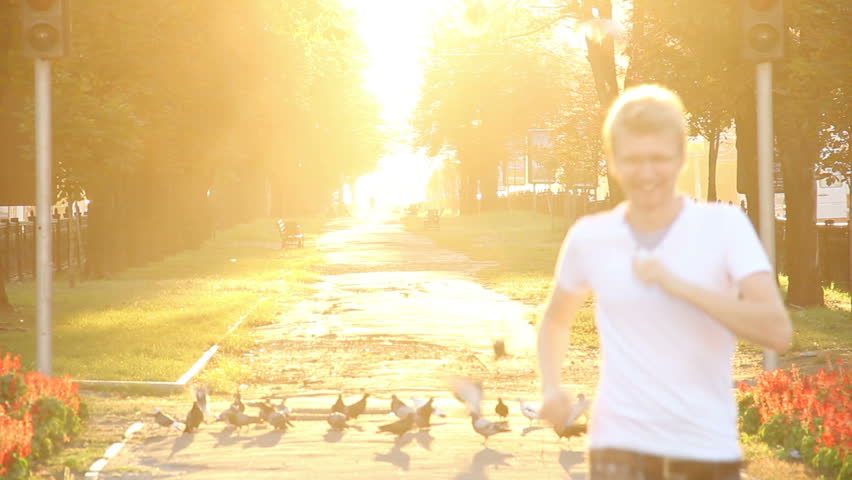 Happy running male scares birds fly away, life is good, sunshine